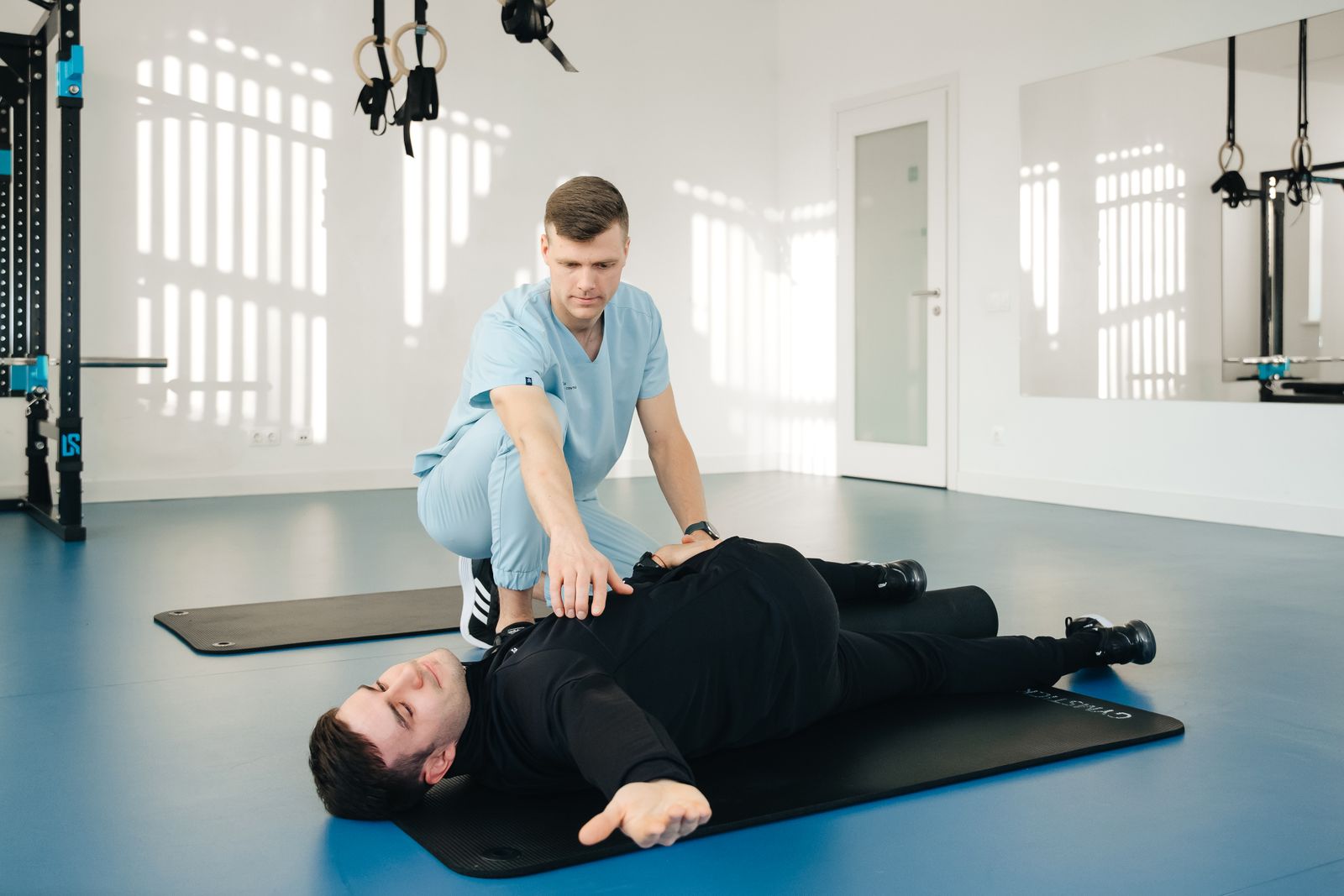A clinician guiding a patient through a rehabilitation exercise